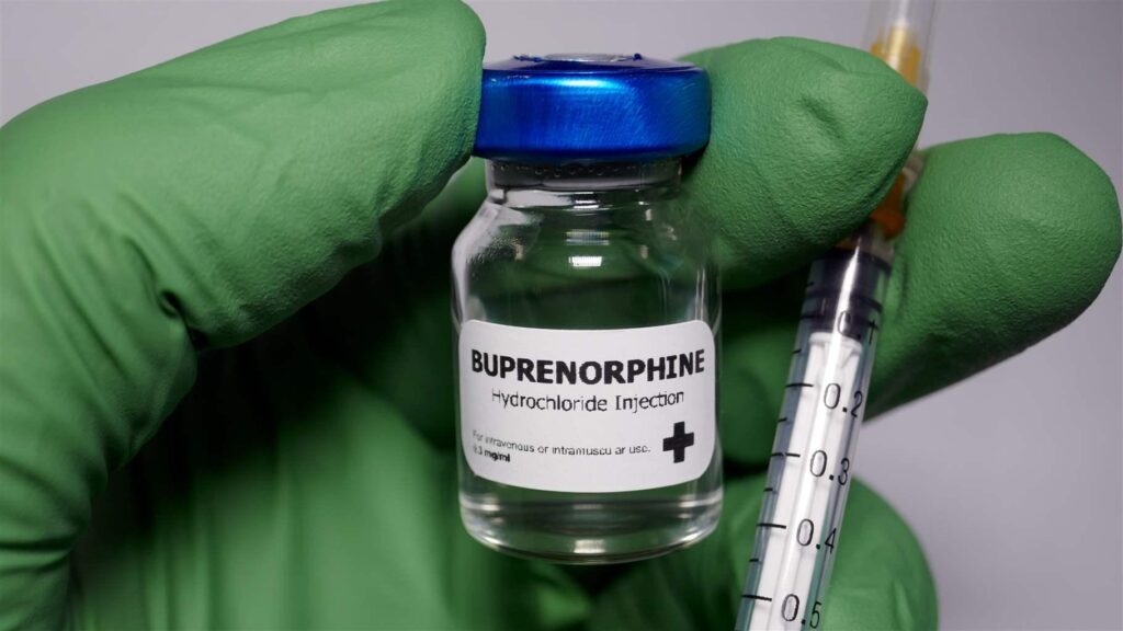 Gloved hand holding buprenorphine and syringe