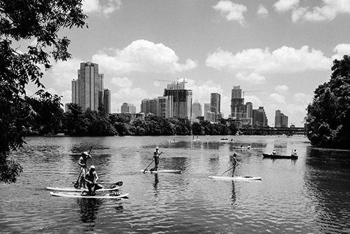 People paddleboarding on Austin's Lady Bird Lake. Photo by Tomek Baginski on Unsplash.