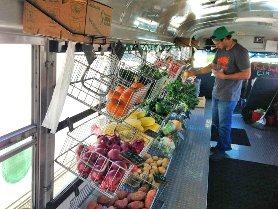Man selecting produce from Boston Fresh Truck