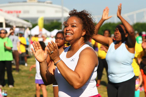 People smiling and moving at a Louisville wellness day