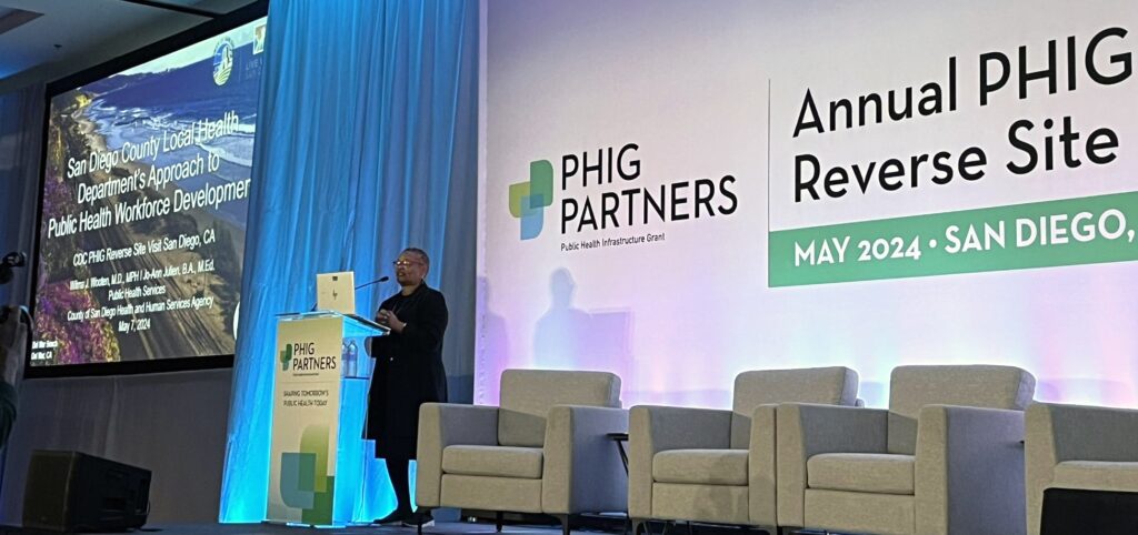 Wilma Wooten standing at lectern on conference stage