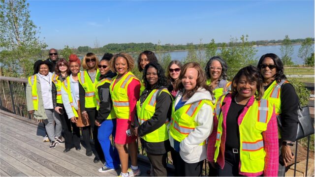 Shelby Co. health department director and employees wearing yellow vests standing outside