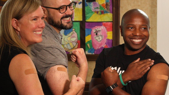 Wisconsin health leaders showing their arms where they've just received flu shots