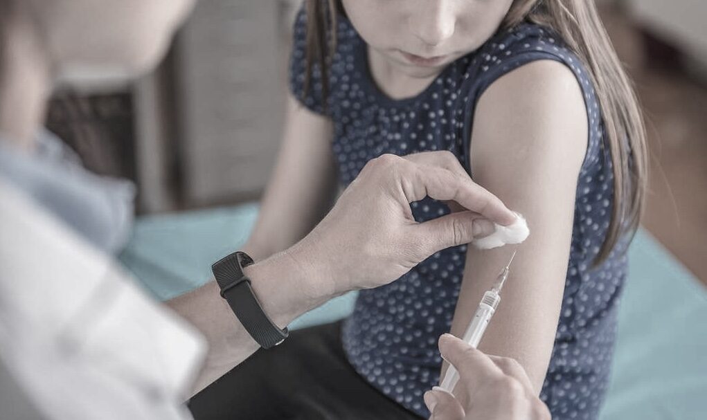School-aged girl getting MMR vaccine