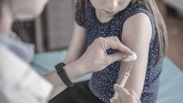 School-aged girl getting MMR vaccine