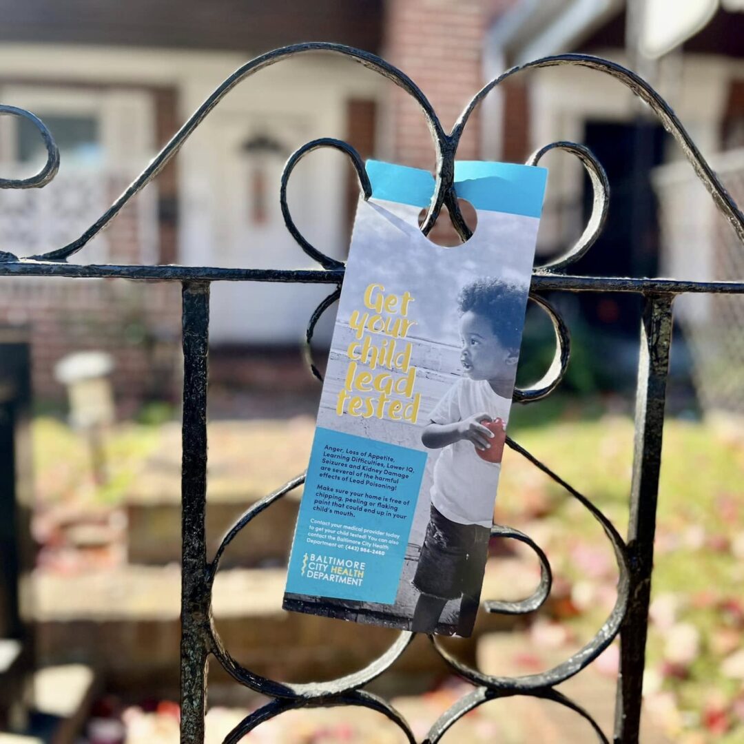 Lead education flyer hung on a Baltimore resident's front gate