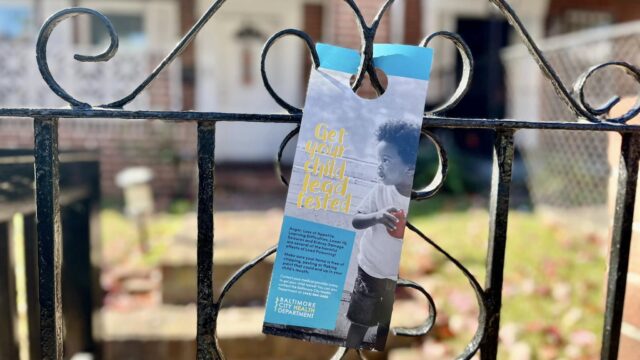 Lead education flyer hung on a Baltimore resident's front gate
