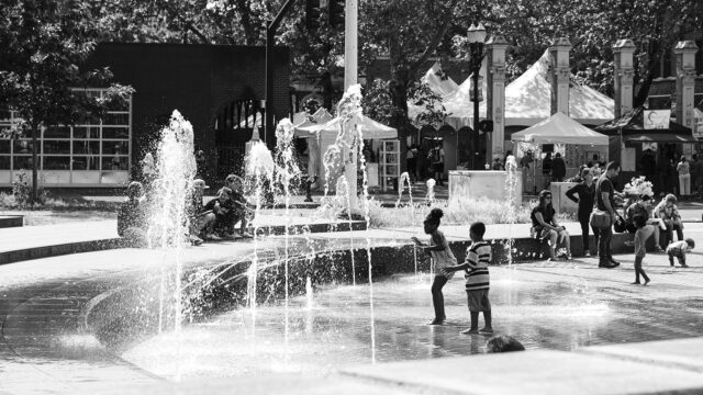 Children playing in a city fountain