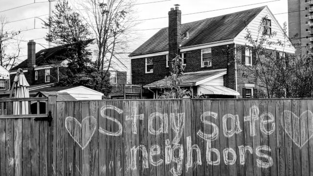 ity fence spray-painted with the words "stay safe, neighbors." Photo by Bill Nino from Unsplash