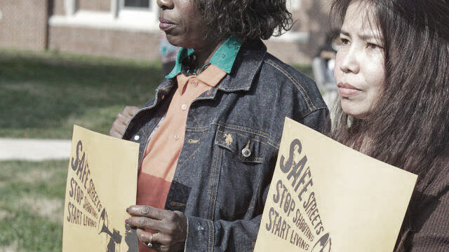 Two women holding posters that read "Safe Streets. Stop Shooting. Start Living."Baltimore violence prevention event, 2012