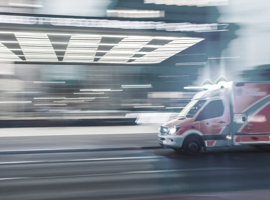 ambulance rushing down city street