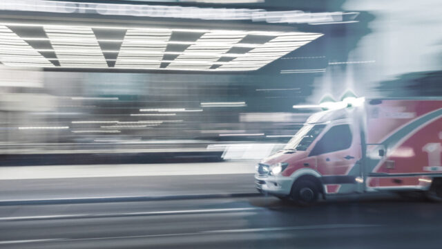 ambulance rushing down city street