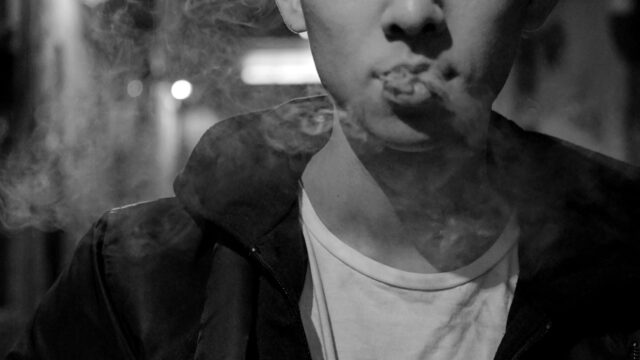 Closeup of young person exhaling e-cig vapor. Original photo by Jocelyn Wong on Unsplash.